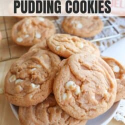 Baked butterscotch pudding cookies with white chocolate chips on a white plate.
