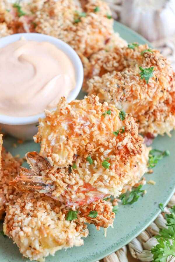 Close up of air fried panko shrimp on a green plate.