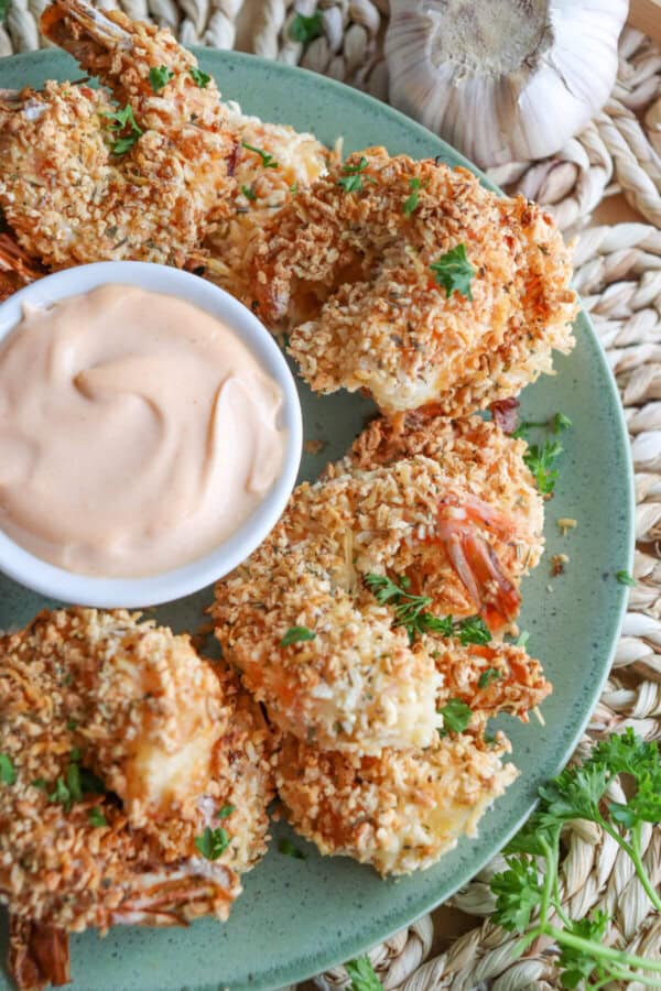 Close up of air fried panko shrimp on a green plate.
