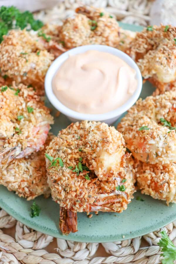 Close up of air fried panko shrimp on a green plate.