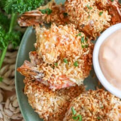 Close up of air fried panko shrimp on a green plate.