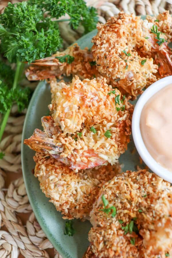 Close up of air fried panko shrimp on a green plate.