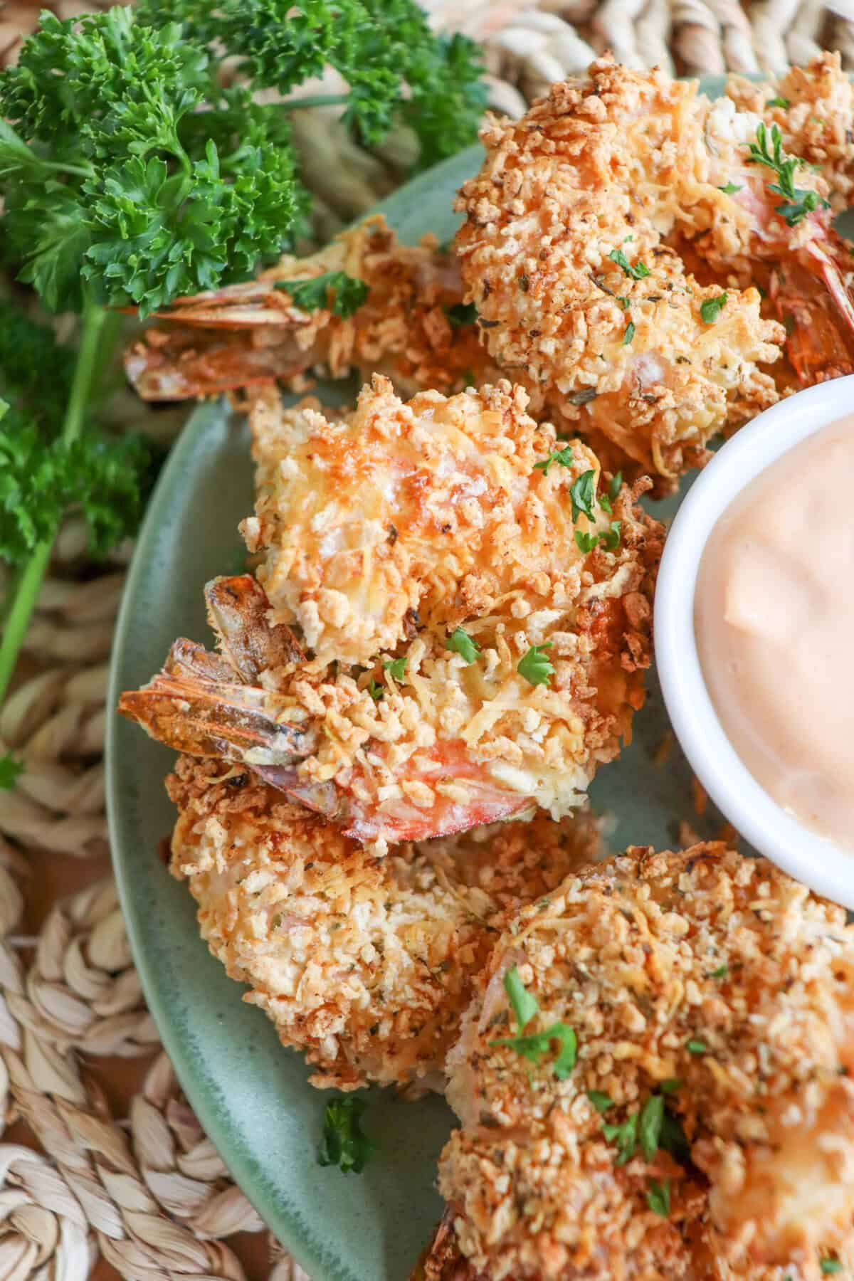 Close up of air fried panko shrimp on a green plate.