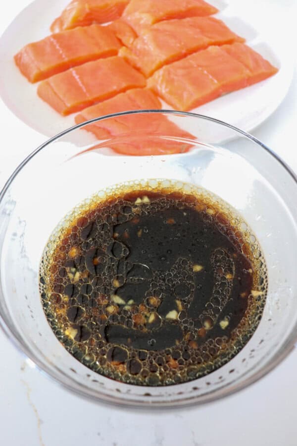 Bourbon salmon marinade mixed in a clear glass bowl.