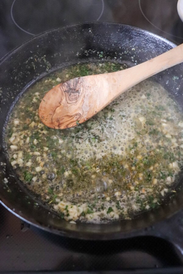 Melted butter and garlic sauteed in a cast iron skillet.