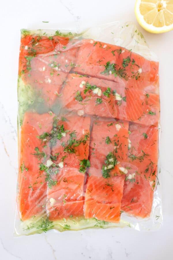 Salmon in a freezer bag with lemon garlic marinade.