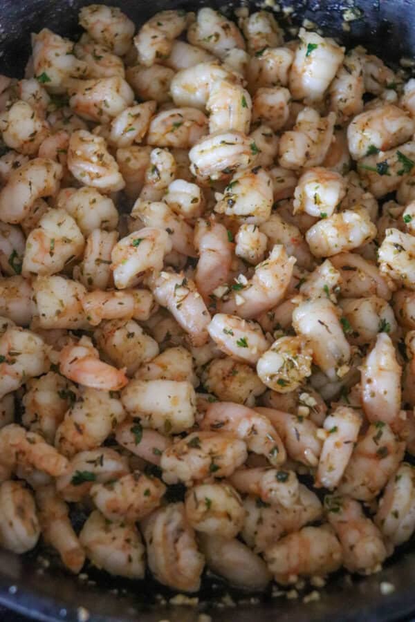 Shrimp cut into thirds and cooked in a cast iron skillet with seasoning.