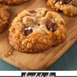 Oatmeal chocolate chip cookies on a wooden cutting board.