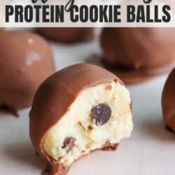 Cookie dough ball with a chocolate coating with a bite taken out.