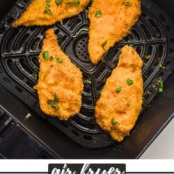 Breaded chicken strips in the basket of an air fryer.