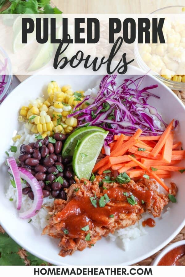 Pulled pork and vegetables over rice in a large white bowl topped with barbecue sauce.