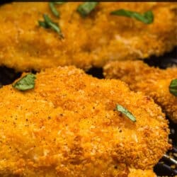 Breaded chicken strips in the basket of an air fryer.