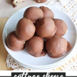 Cookie dough balls with chocolate coating in a stack on a white plate.