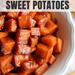 Sweet potatoes covered in a brown sugar glaze in a large white bowl.