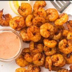Seasoned shrimp on a white counter with a small bowl of spicy mayo.