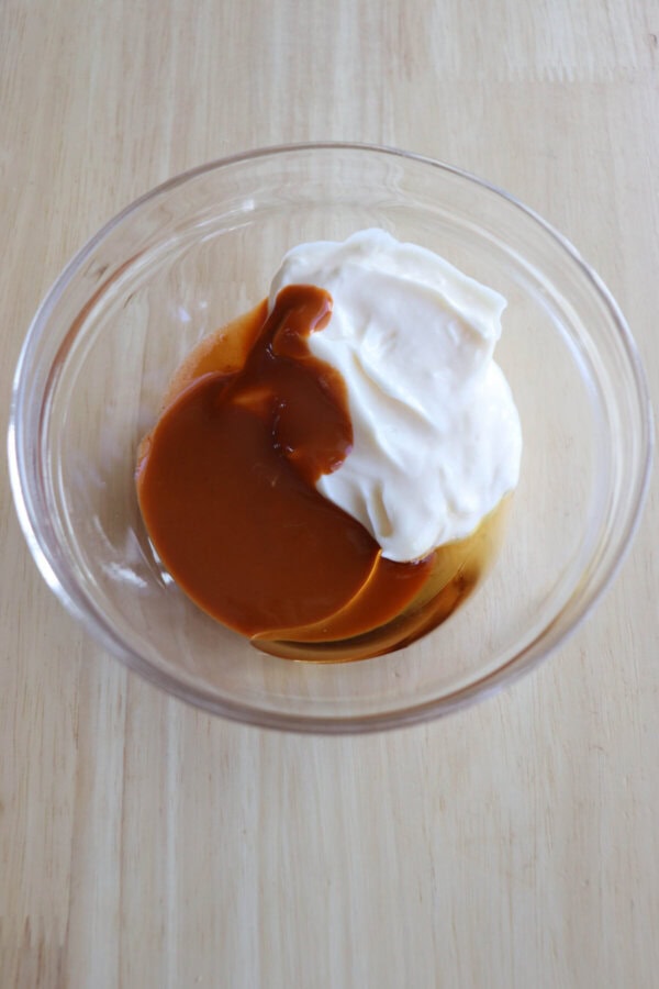 Spicy mayo ingredients in a small glass bowl.
