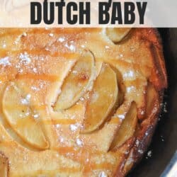 Dutch baby with apple slices and a caramel drizzle in a cast iron skillet.
