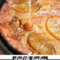Dutch baby with apple slices and a caramel drizzle in a cast iron skillet.