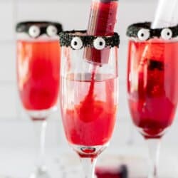 Champagne glasses with black frosting on the rim, candy eyes and sprite died red with a syringe full of food grenadine.