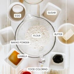 Ingredients for Halloween pancake in bowls on a white table.