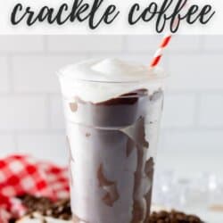 Chocolate coated plastic cup filled with coffee, topped with whipped cream and a red and white striped straw.
