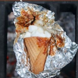 Sugar cone topped with chocolate and marshmallows wrapped in foil.