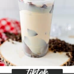 Coffee with cream in a plastic cup with cracked chocolate and whipped cream.