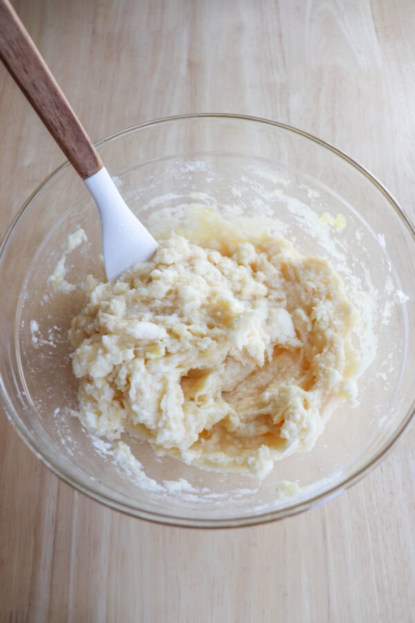 Butter and sugar creamed together in a clear glass bowl.