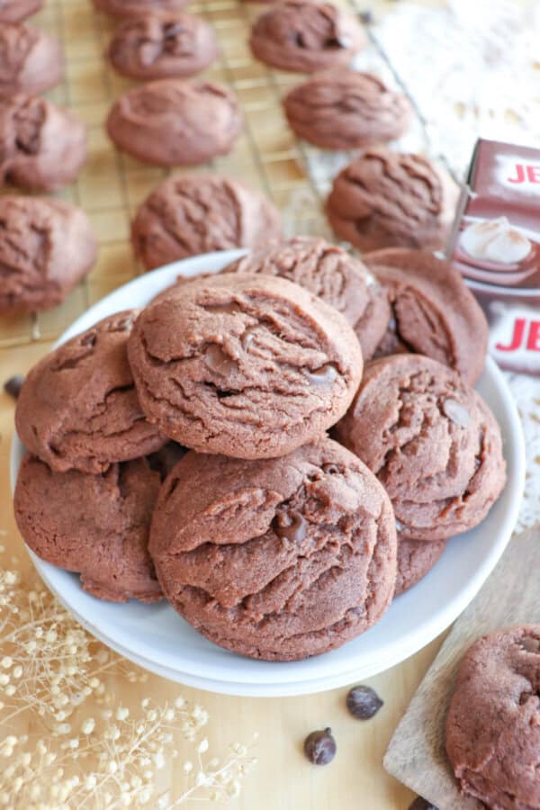 Chocolate pudding cookies stacked on a white plate.