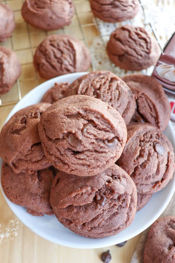Chocolate pudding cookies stacked on a white plate.