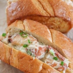 Crab salad mixture in a roll made of toasted and sliced garlic buttered french bread.