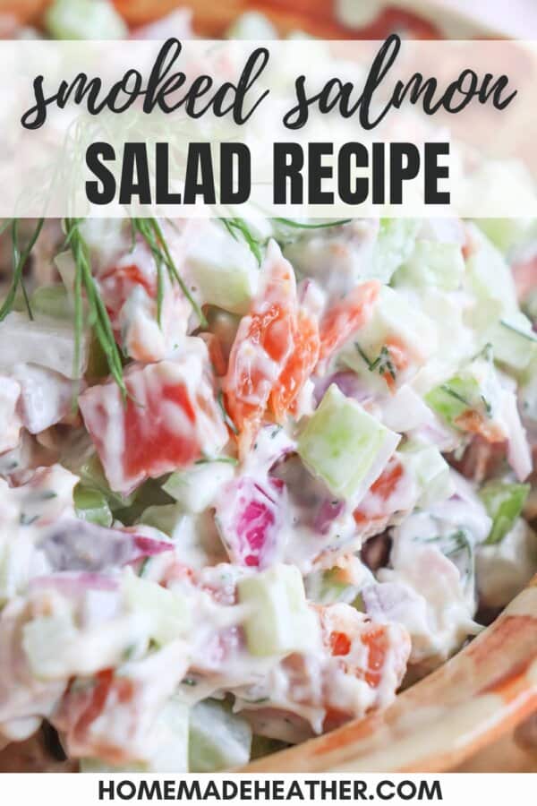 Diced celery, red onion and smoked salmon covered in creamy white mayonnaise in a clay bowl with a sprig of fresh dill on top.