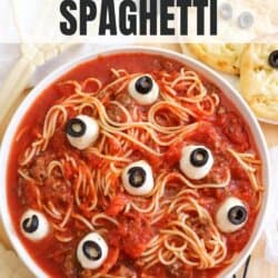 Spaghetti in a white bowl with mozza eyes.