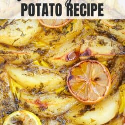 Potato wedges covered in a zesty lemon sauce with herbs in a white casserole dish.