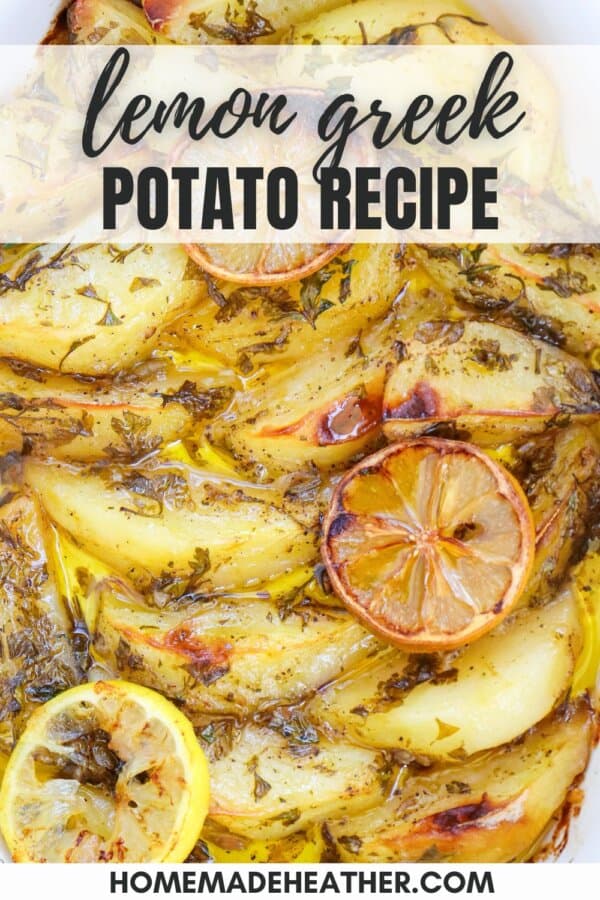 Potato wedges covered in a zesty lemon sauce with herbs in a white casserole dish.
