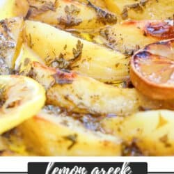Potato wedges covered in a zesty lemon sauce with herbs in a white casserole dish.