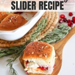 Hawaiian rolls filled with turkey and cranberry sauce in a white baking dish.