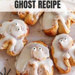 Cinnamon rolls in the shape of a ghost with candy eyes.