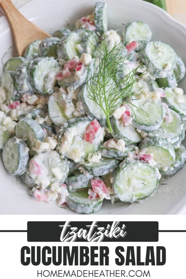 Sliced cucumbers in tzatziki sauce with diced pickled onions and dill in a white bowl.