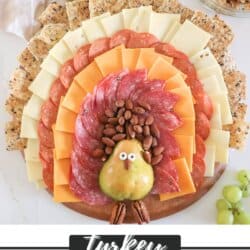 Charcuterie Board in the shape id a turkey with pear body and cheese and cracker feathers.