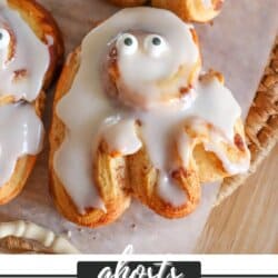 Cinnamon rolls in the shape of ghosts with candy eyes.