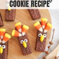 Wafer chocolate covered cookie with candy corn feathers, candy eyes and an m&m beak.