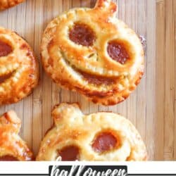 Hand pies in the shape of Jack Skellington on a wood cutting board.