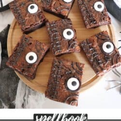 Brownies decorated as a spell book from Hocus Pocus on a wooden cutting board.