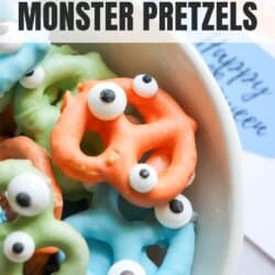 Colorful chocolate dipped pretzels with candy eyes in a white bowl.