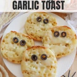 Rounds of garlic toast with two olive eyes and melted cheese.