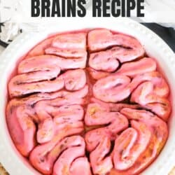 Cinnamon rolls in the shape of a brain with pink icing.