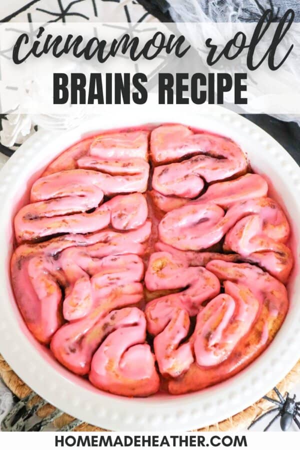 Cinnamon rolls in the shape of a brain with pink icing.