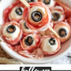 Mozzarella balls wrapped in prosciutto with black olive eyes in a white bowl.