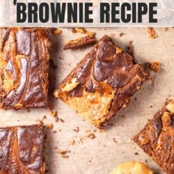 Chocolatey brownies with peanut butter swirls, cut into squares on parchment paper.